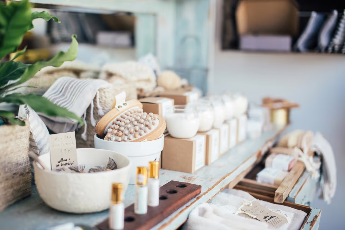 A shop counter lined with jars, soaps and brushes in woven baskets